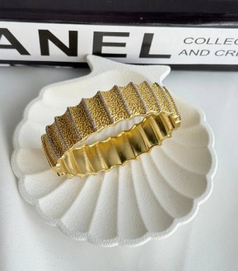 دستبند طلایی با طراحی لایه‌ای و جواهرات درخشان